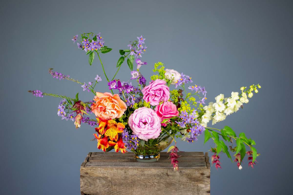 floral design multicolored flowers in vase on wooden surface pattern